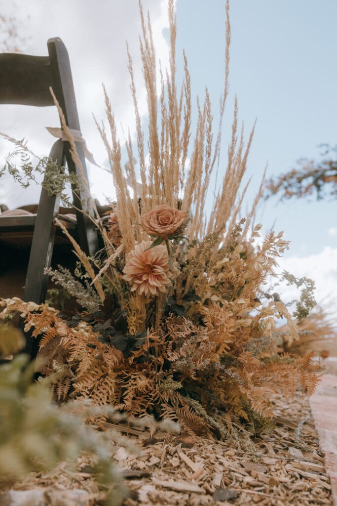 Luxury autumn wedding floral design with burgundy dahlias and seasonal foliage in natural settingfine