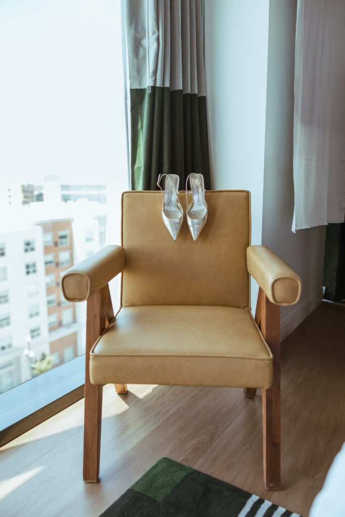 Silver bridal heels on mid-century modern leather armchair, Le Méridien Salt Lake City