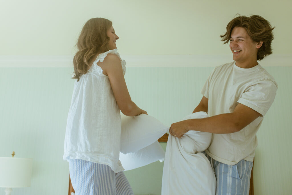 A spontaneous pillow fight breaks out mid-session, capturing the playful, unscripted energy Blake and Kaylee wanted their first anniversary photos to feel like.