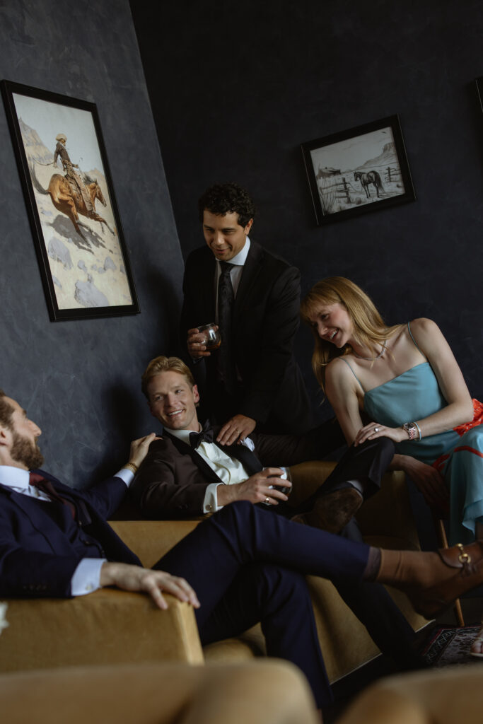 Groomsmen and bridesmaid laughing at Van Ryder lounge at Le Méridien Salt Lake City

