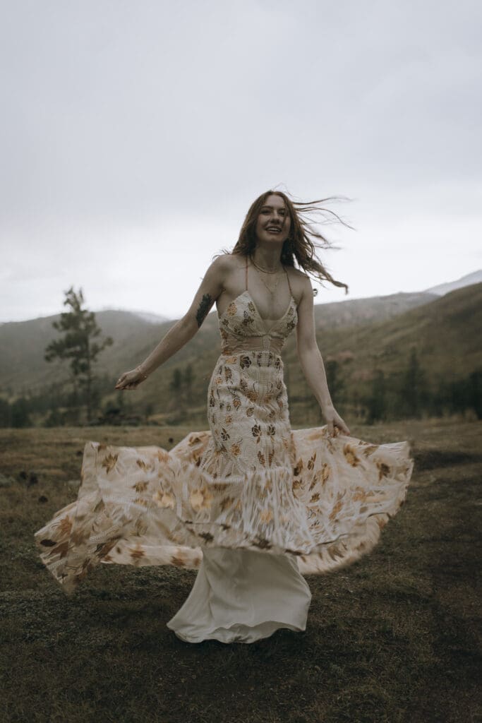 bride spins in the wind enjoying her wedding day