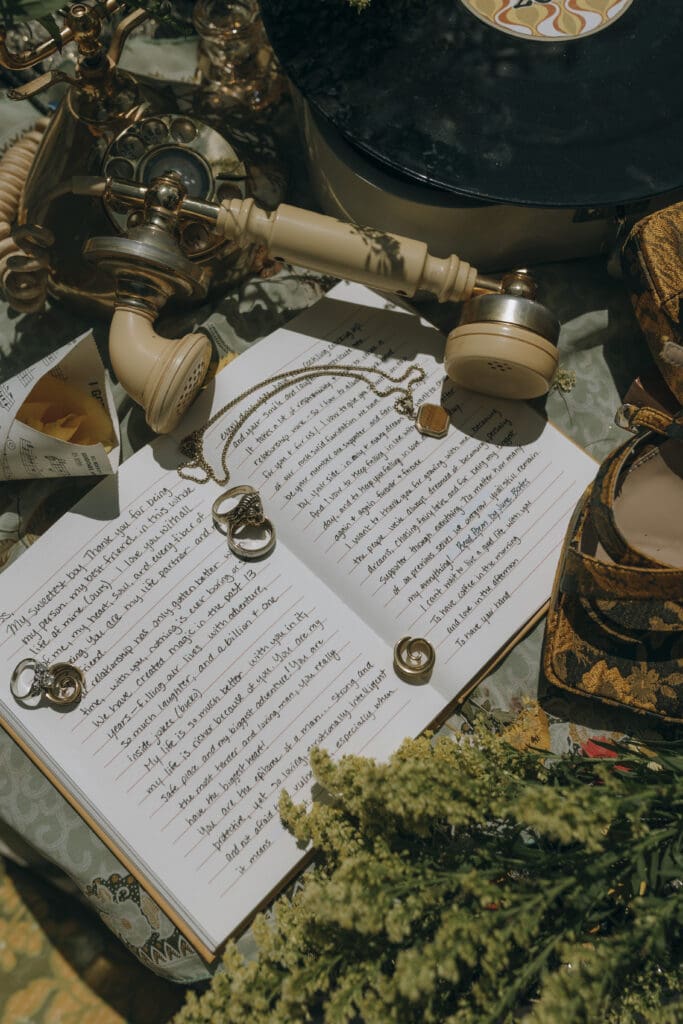  Vintage-inspired wedding flat lay featuring vows, wedding rings, retro record, and golden platform heels