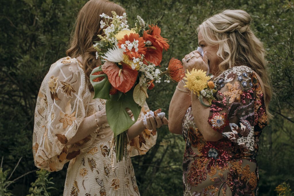 Documentary style bride sheds a tear with mother of the bride before ceremony