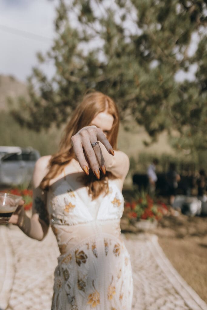 editorial bride shows ring during reception