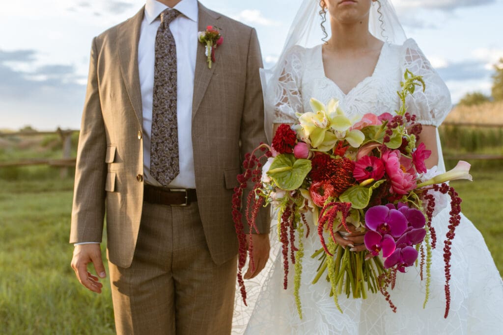 unique wedding photography posing with florals wes Anderson inspired