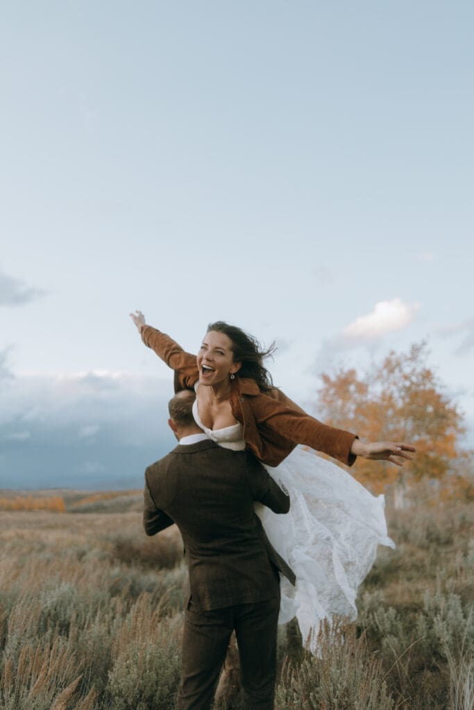 Whimsical Bride and groom golden hour portrait at private mountain estate with autumn colors