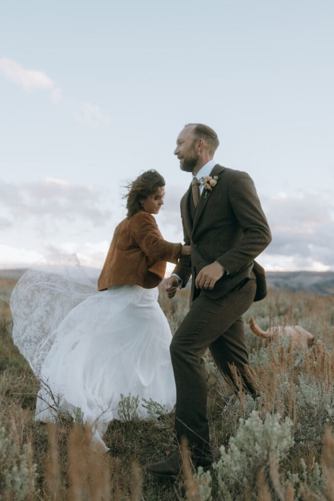 Bride and groom golden hour portrait at private mountain estate with autumn colors featured in Junebug Weddings