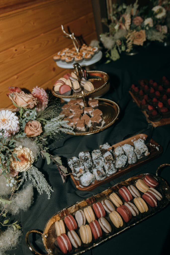 Autumn dessert table spread with burgundy frosting and gold accents by Tulie Bakery