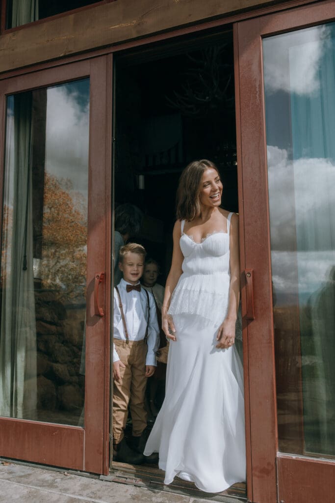 Bride before the wedding peeking her head out on the brisk day. 
